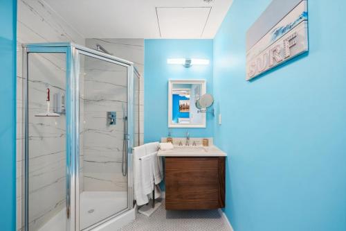 a bathroom with a shower and a sink at Sunset Sands Retreat in Venice