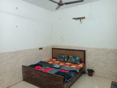 a bed in a room with a ceiling at Shri Ram Janam Homestay 300 Meter from Ram Mandir in Ayodhya