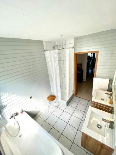 a bathroom with a tub and a sink at Ferienwohnung Blautalblick in Blaustein