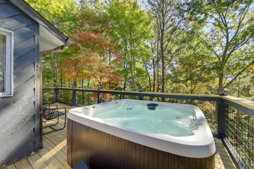 a hot tub on the deck of a house at Hot Tub and Pet-Friendly! Gatlinburg Resort Cabin in Gatlinburg