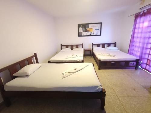 Postel nebo postele na pokoji v ubytování Hotel Los Arcangeles