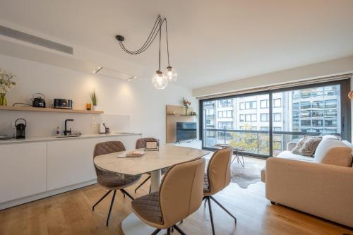 a kitchen and living room with a table and chairs at Cosy Coast in Knokke-Heist