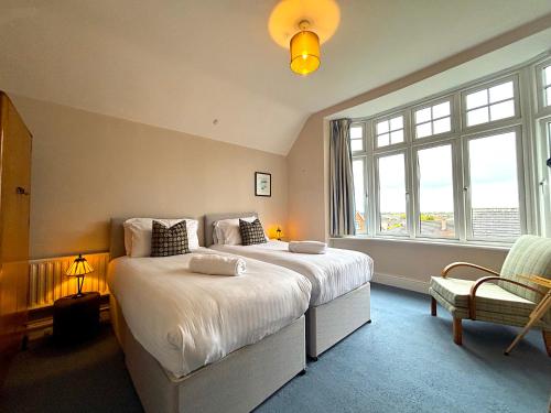 a bedroom with a large bed and a large window at Spacious 4-Bed Home - Oswestry - Families & Groups in Oswestry