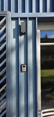 a close up of a metal door on a building at Saulės apartamentai su vaizdu į Kušių marias in Neringa