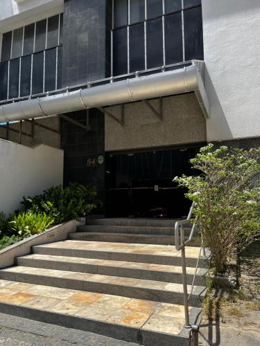 a building with stairs in front of a building at Quarto a 10m da praia ao lado de Pubs e Restaurantes in Recife