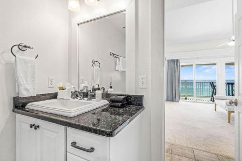 a bathroom with a sink and a large mirror at Blue Tide 6B in Inlet Beach
