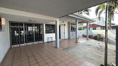 an empty porch of a house with a patio at RUMAH BENDANG ALOQSETAQ -Private PooL - Panoramic view of rice fields and Alor Setar Tower in Alor Setar