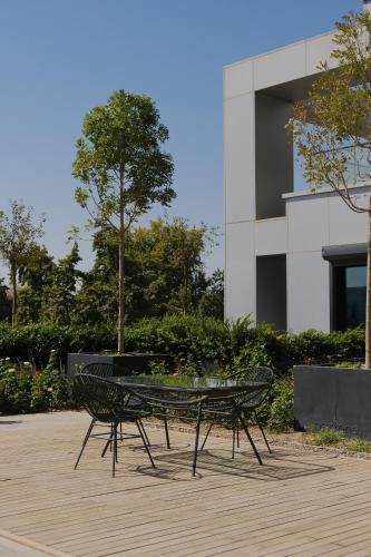 a table and chairs in front of a building at Nest One Luxe, Элитные апартаменты с террасой и панорамным видом 067 in Tashkent