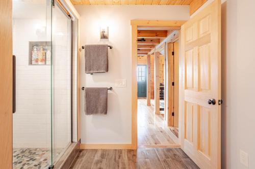 a bathroom with a shower and a glass door at The Greylock Cabin in Florida