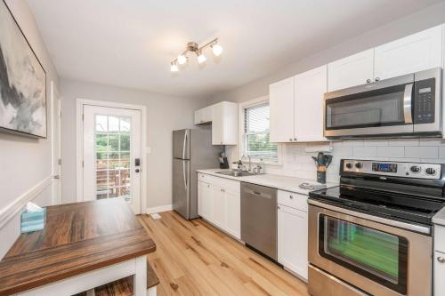 a kitchen with white cabinets and stainless steel appliances at Valley Ridge Retreat - For 8 in Cincinnati