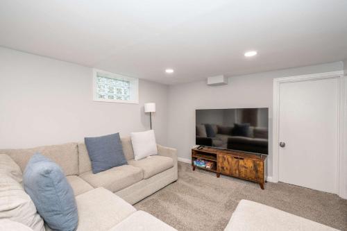 a living room with a couch and a flat screen tv at Valley Ridge Retreat - For 8 in Cincinnati