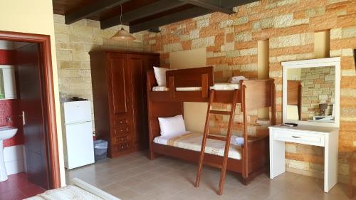 a room with a bunk bed and a mirror at Ornella Beach Resort & Villas in Sivota