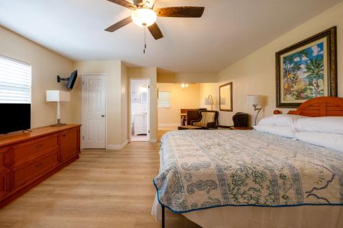 a bedroom with a bed and a flat screen tv at Siesta Motor Inn By Townhouse Kennedy Space Center Titusville I 95 in Titusville
