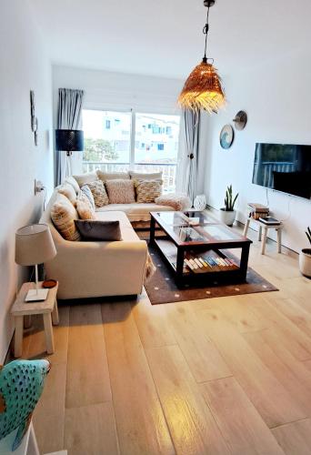 a living room with a couch and a coffee table at Punta Panoramic - Punta Mujeres in Punta Mujeres
