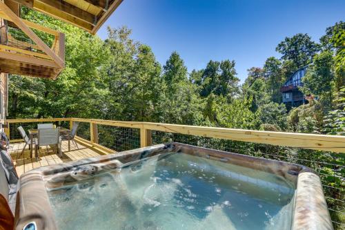 a hot tub on the deck of a house at Hot Tub and Resort Perks! Gatlinburg Mtn Retreat in Gatlinburg