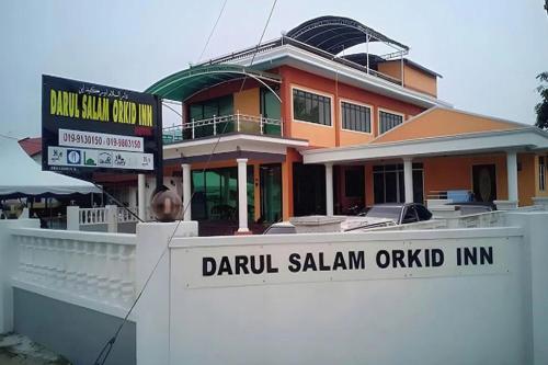 a building with a sign in front of it at Darul Salam Orkid Inn in Dungun