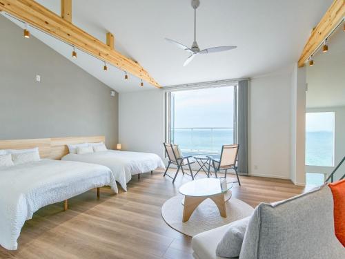 a bedroom with two beds and a table and chairs at Ansolas-Villa - Vacation STAY 54282v in Tusi