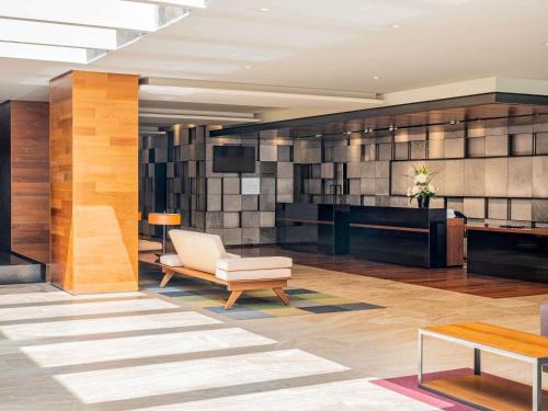 a lobby with a chair and a table at The Paragon Hotel Mexico Santa Fe By Accor in Mexico City