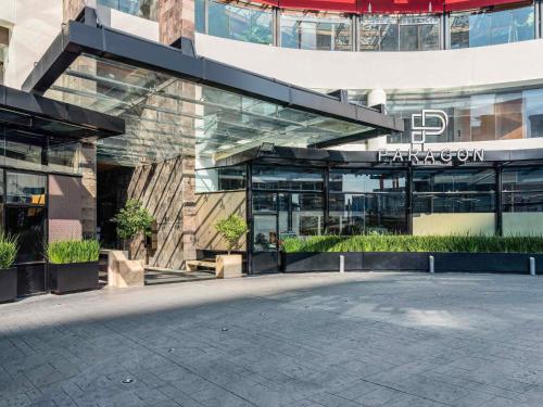a large office building with a courtyard in front of it at The Paragon Hotel Mexico Santa Fe By Accor in Mexico City
