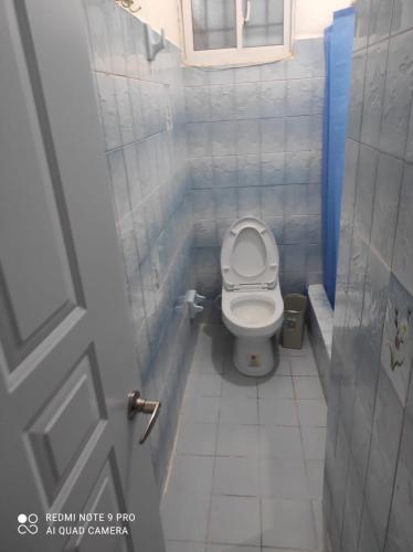 a small bathroom with a toilet in a stall at Sweet beach apartment in San Felipe de Puerto Plata
