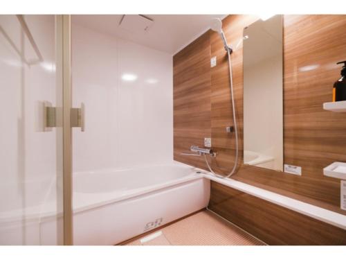 a bathroom with a bath tub and a shower at HOTEL ALL IN Kumamoto - Vacation STAY 55117v in Hanabatachō
