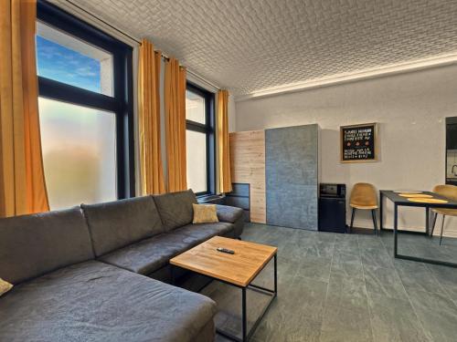 a living room with a couch and a table at Loft Apartment in Odorheiu Secuiesc
