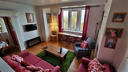 a living room with a couch and a table at A Baronial Hall apartment - great views of Loch Fyne 