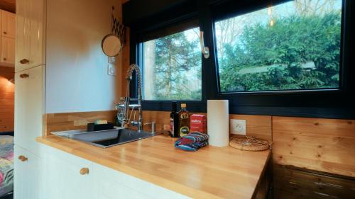 a kitchen counter with a sink and a window at Les Chalets Horizon in Saint-Just-de-Claix