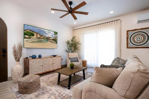 a living room with a couch and a ceiling fan at Inviting 2BR Condo in Mavila Resort at Quivira in Cabo San Lucas