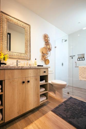 a bathroom with a sink and a toilet and a mirror at Inviting 2BR Condo in Mavila Resort at Quivira in Cabo San Lucas