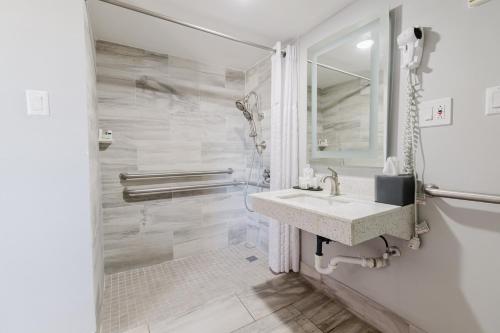 a white bathroom with a sink and a mirror at La Quinta Inn by Wyndham Amarillo Mid-City in Amarillo