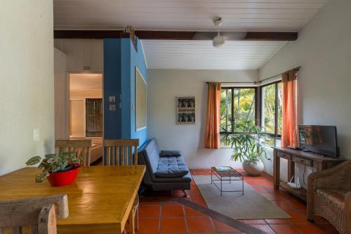 a living room with a couch and a table at Pousada Vila Tamarindo Eco Lodge in Florianópolis