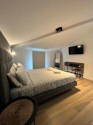 a bedroom with a bed and a television and a table at Residence Pelin in Treviso