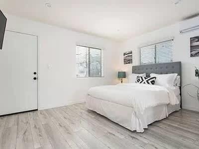a large white bedroom with a large white bed at Sunny Studio in the Heart of Venice - A in Los Angeles