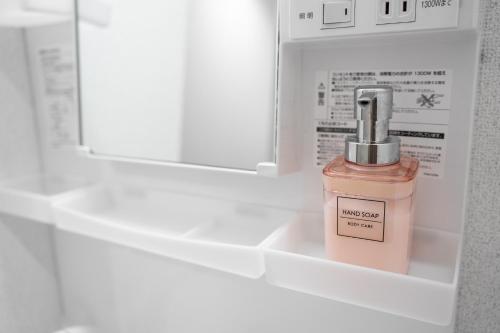 a bottle of pink perfume sitting in a drawer at Charmant House III - Vacation STAY 20377 in Minamifurano