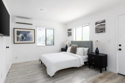 a white bedroom with a bed and a table at Sunny Studio in the Heart of Venice - B in Los Angeles