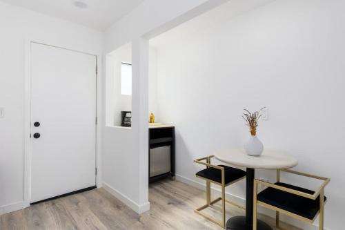 a white room with a table and a table and chair at Sunny Studio in the Heart of Venice - B in Los Angeles