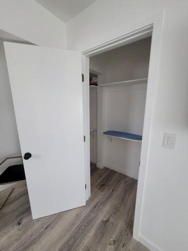 an empty room with a white closet with a blue bench at Sunny Studio in the Heart of Venice - B in Los Angeles