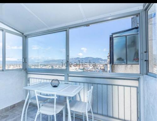 a white table and chairs on a balcony with a view at Estudio Moderno la mejor vista al puerto deportivo in Empuriabrava