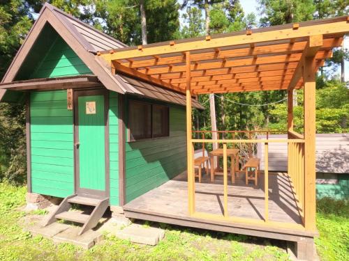 a shed with awning and a table and chairs at Nikko Manaka Forest Camp & Resort - Vacation STAY 65320v in Nikko