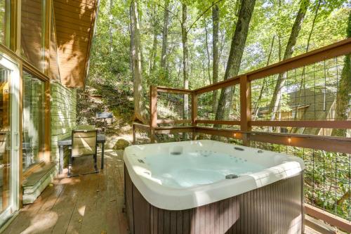 a bathroom with a tub in the woods at Cabin with Hot Tub 2 Mi to Downtown Gatlinburg! in Gatlinburg