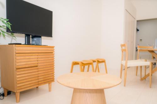 a living room with a tv and a table and chairs at Greenfield - Vacation STAY 20425 in Sasebo