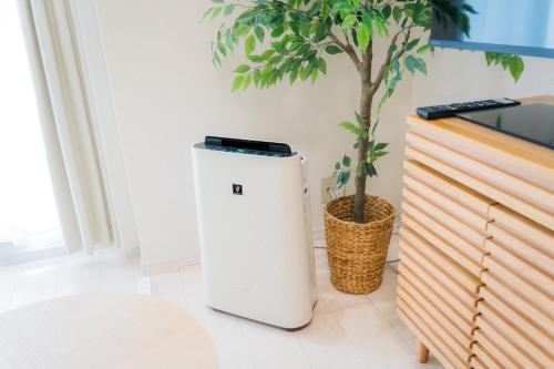 a small white refrigerator sitting next to a plant at Greenfield - Vacation STAY 20425 in Sasebo