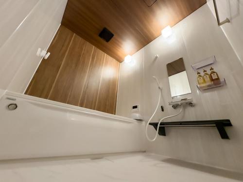 a bathroom with a sink and a mirror at Tabinoteitaku BREATHTAKEMatsushima - Vacation STAY 66188v in Takagi