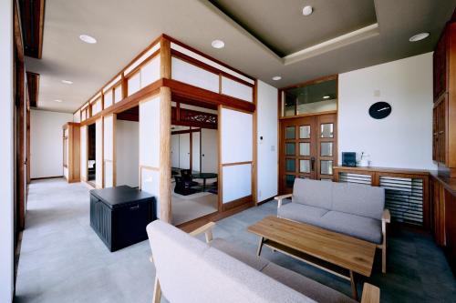a living room with a couch and a table at Nostalgia Oiso Awaji - Vacation STAY 66330v in Kusumoto