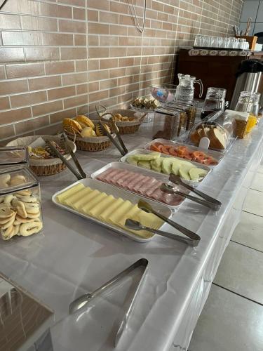 a buffet with many different types of food on a table at GH Barra da Lagoa in Florianópolis