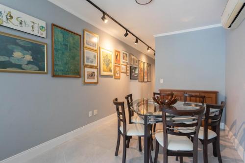 a dining room with a glass table and chairs at Apartamento Climatizado com Garagem e Wi-Fi in Auxiliadora