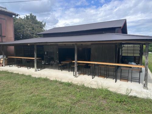 a building with tables and chairs in front of it at KominkaGlamping NAYA - Vacation STAY 20482 in Chosei