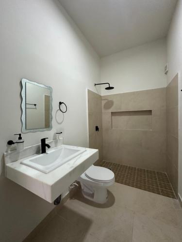 une salle de bain blanche avec un lavabo et des toilettes dans l'établissement Deptos Modernos Colonia México, à Mérida
