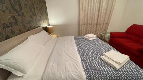 a bedroom with a bed and a red couch at Casa Amore a Bergamo in Bergamo